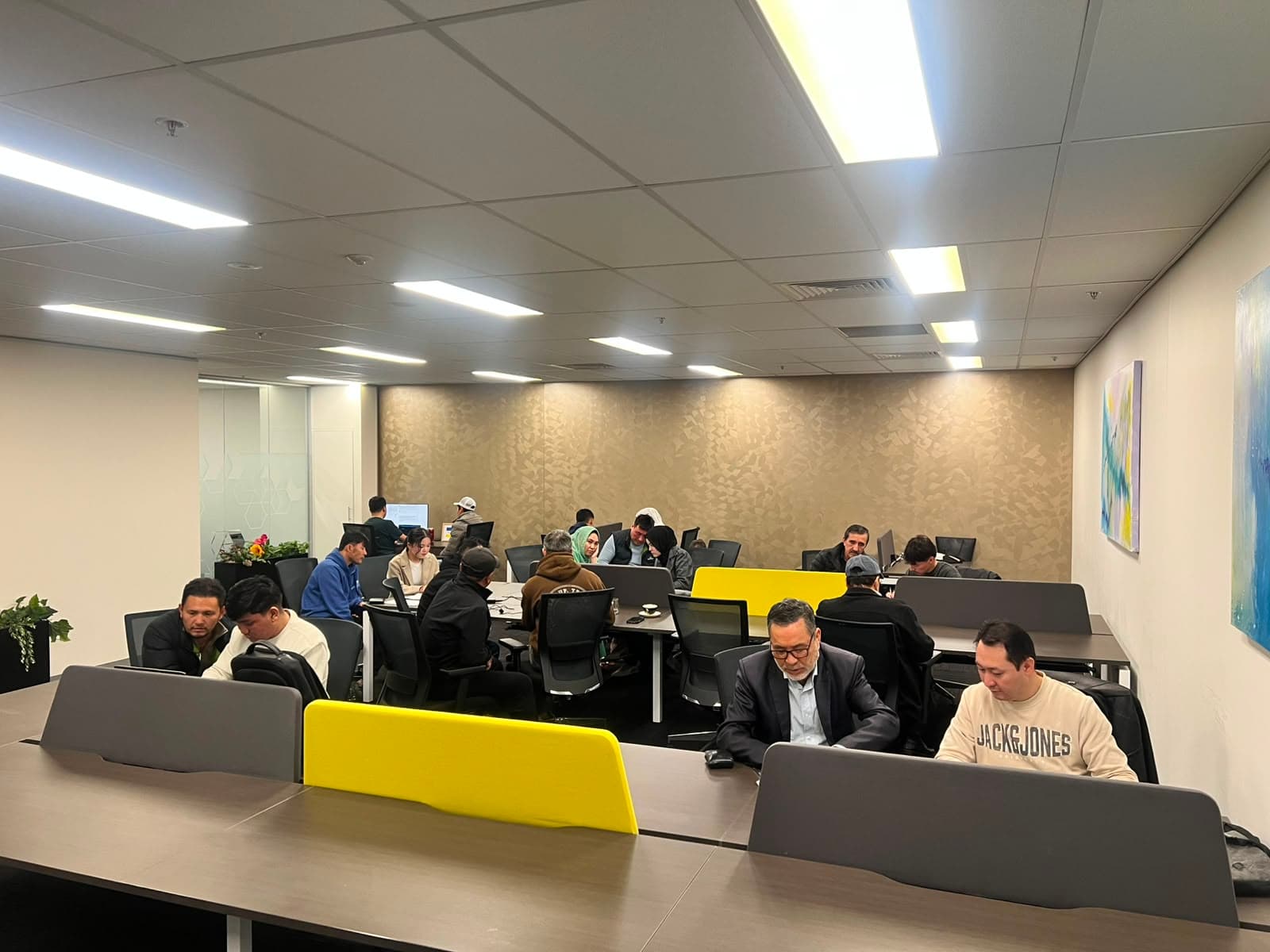 Community members seated at desks during a support session